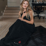 Person using HEALiX-Z Sauna Blanket, relaxing comfortably while the blanket is wrapped around them