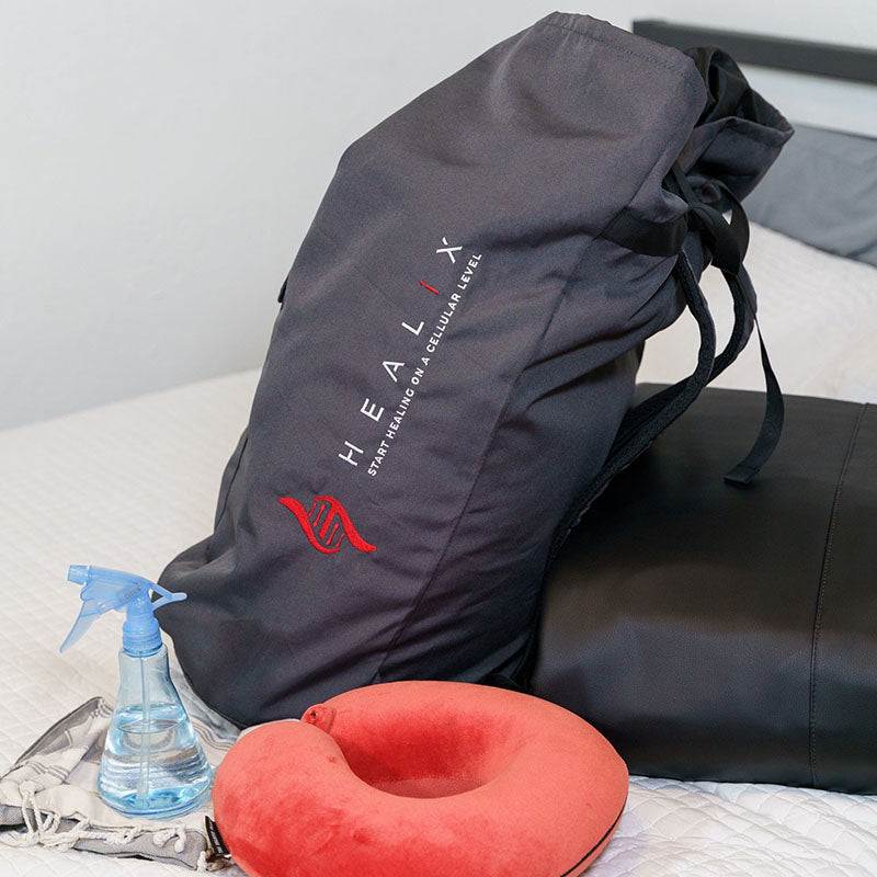 HEALiX Stash Backpack displayed on BED, showing its organized compartments and fashionable look