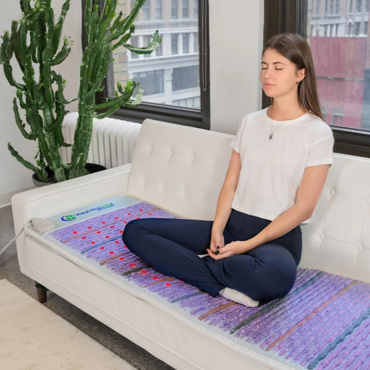 The Platinum PEMF Mat placed on a sofa to show its versatility.