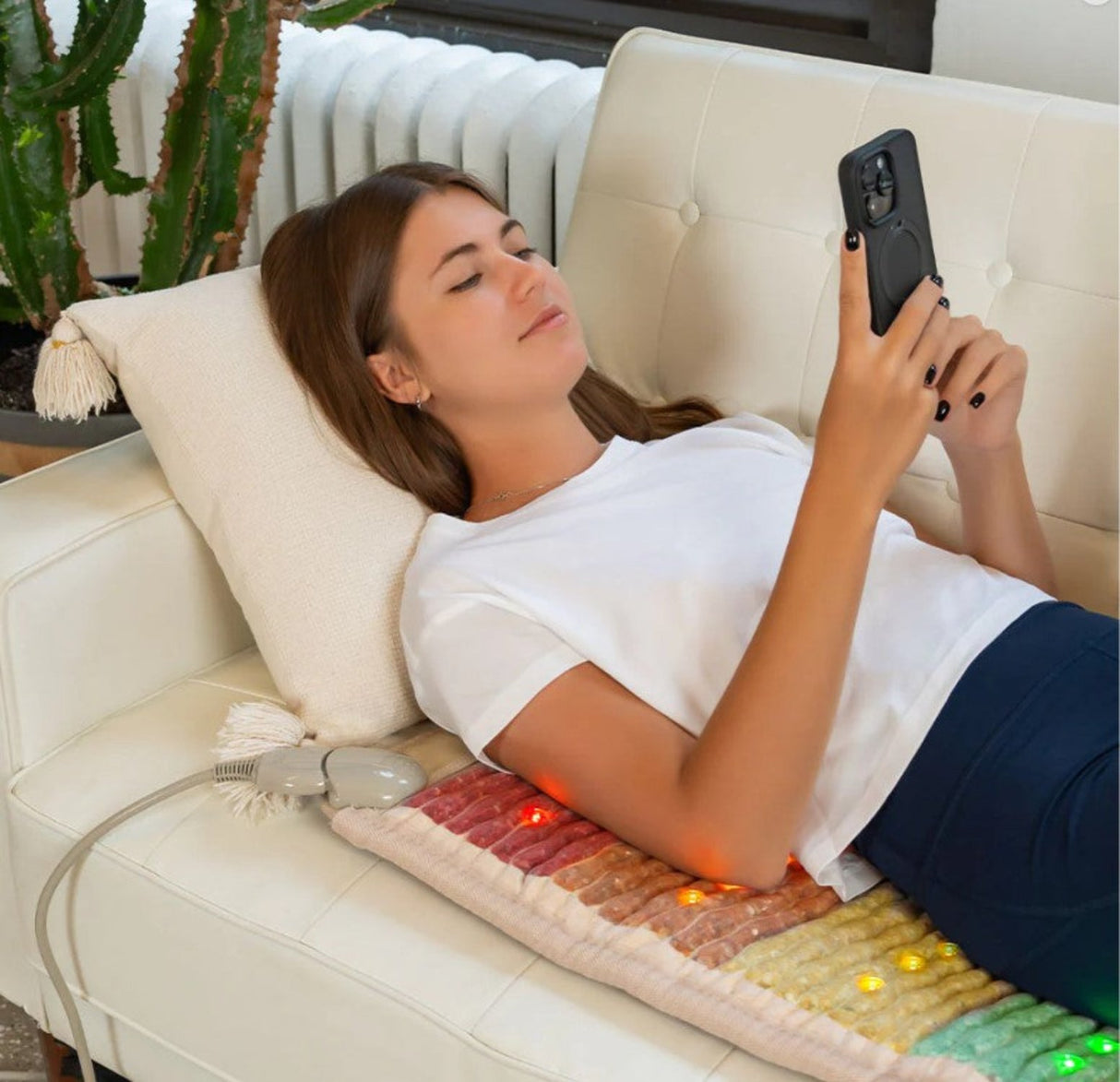 Person lying on the Healthy Line Rainbow Chakra Mat 4020, experiencing PEMF and photon therapy.