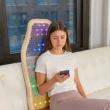 In-Use Image: "Person comfortably seated on the HealthyLine Rainbow Chakra Mat™ Chair 5718, enjoying the benefits of gemstone therapy and relaxation