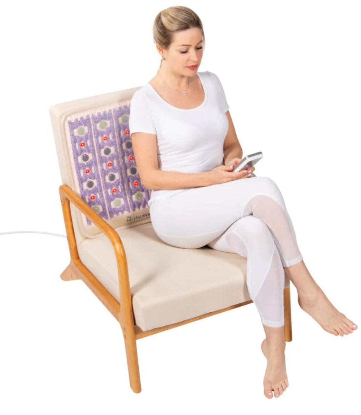 Person using the Healthy Line TAJ-Mat™ 2020 in a calming environment, reflecting its use for relaxation and recovery