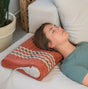 Relaxing with the HealthyLine TAO-Mat® Pillow Soft, designed for optimal neck support.