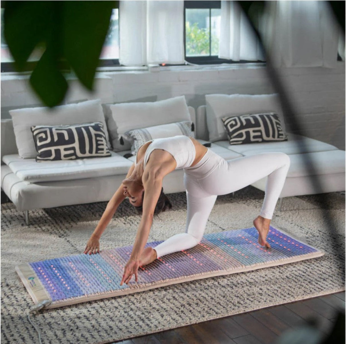 A person practicing yoga or meditation on the mat, promoting wellness and mindfulness