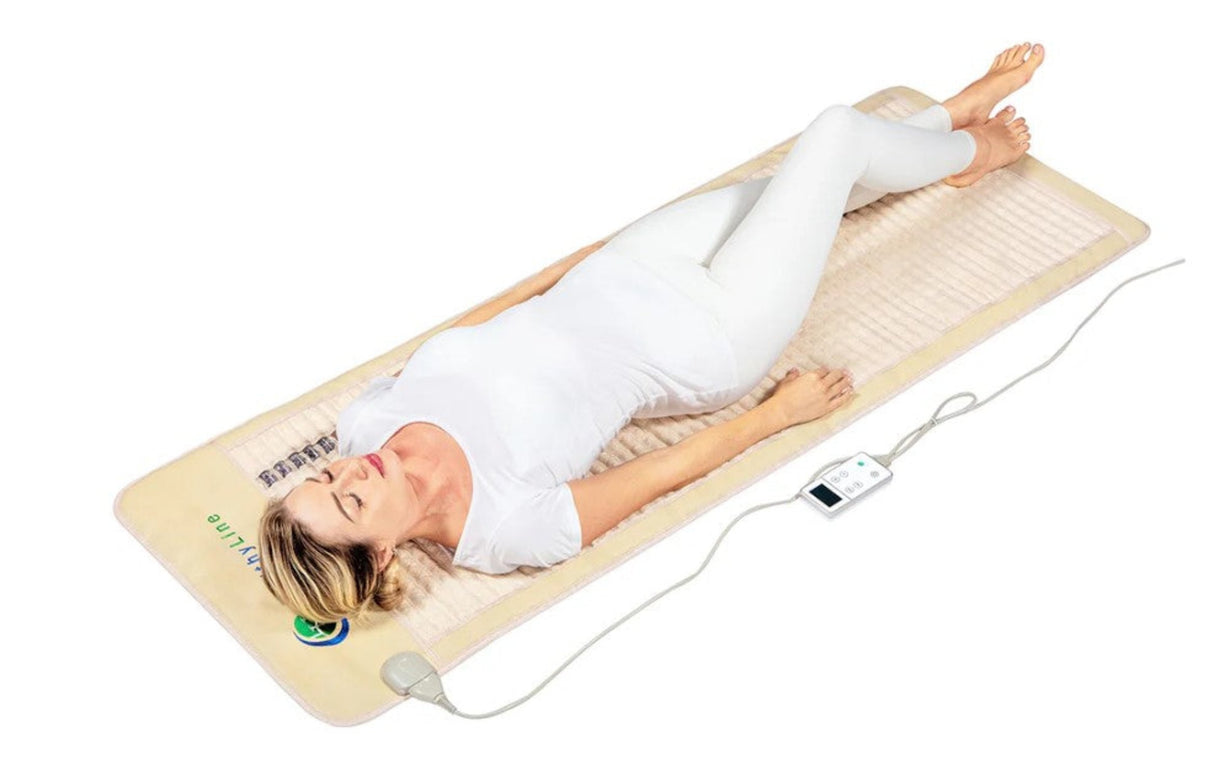 A model comfortably lying on the SOFT-Mat™, demonstrating its use for relaxation and therapy.