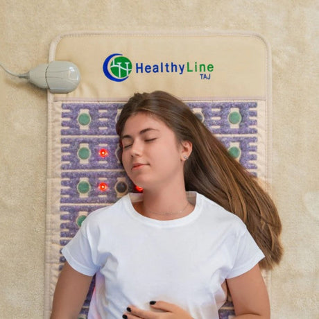 A person lying on the TAJ-Mat™ in a serene environment, highlighting relaxation and therapy benefits