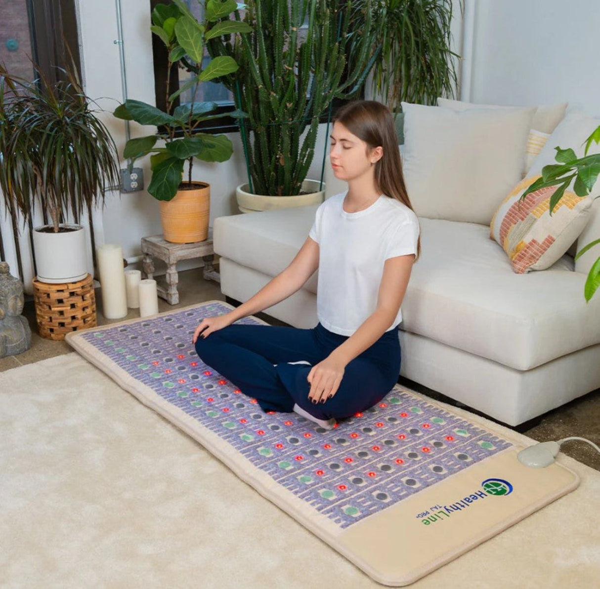 The setting indicates a serene home environment, reinforcing the mat's use for personal wellness.