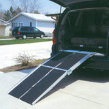 PVI Multifold Reach ramp securely attached to the rear of a car, illustrating safe loading for mobility devices.