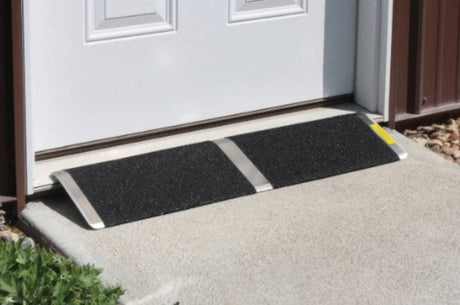 Overhead view of a PVI Standard Threshold Ramp positioned at a doorway, highlighting its practical design.